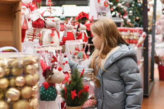 A girl choose the toys for the Christmas tree