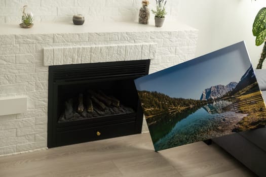 Canvas photo print on wooden floor. Sample of gallery wrapping method of canvas stretching on stretcher bar. Corner and edge of colorful photography closeup.