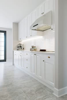 Kitchen with white cabinets, warm lighting and large metal hood. Kitchen interior with marble and brick tiles. 3d rendering.