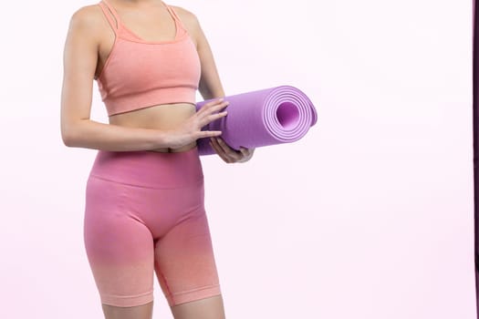 Young attractive asian woman portrait in sportswear with exercising mat. Healthy exercise and workout routine lifestyle concept. Studio shot isolated background. Vigorous