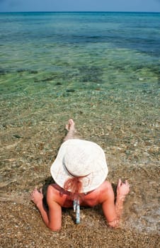 Woman with hat sunbathing