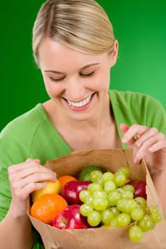Healthy lifestyle - woman with fruit shopping paper bag