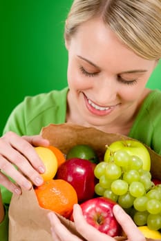 Healthy lifestyle - woman with fruit shopping paper bag