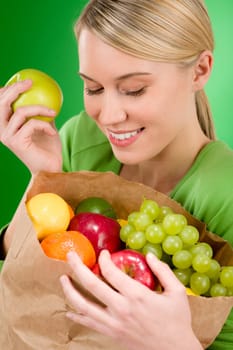 Healthy lifestyle - woman with fruit shopping paper bag