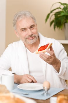 Senior mature man - breakfast at home