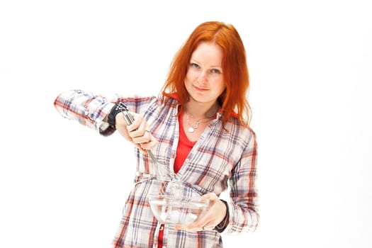 redhead young woman cooks dinner