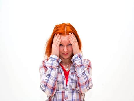 Redhead young woman holding her hand to the head