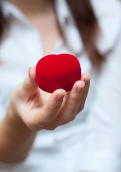 red engagement box holding by hand of young girl