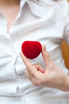 red engagement box holding by hand of young girl