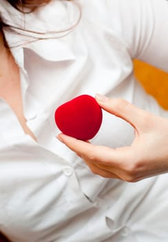 red engagement box holding by hand