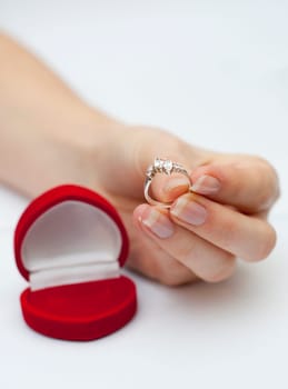 engagement ring held in hand