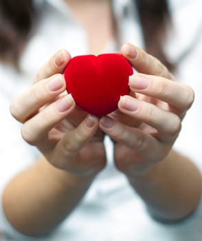 red engagement box holding by hand of young girl