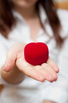 red engagement box holding by hand of young girl