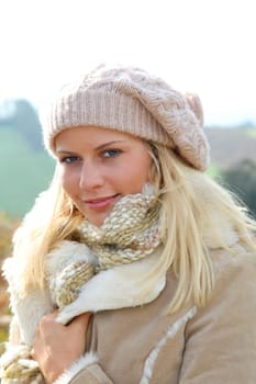 Blond woman wearing wool cap in autumn