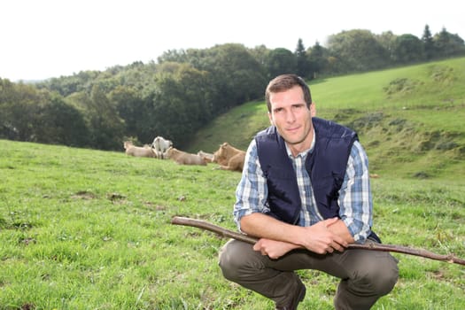 Breeder standing in pasture land
