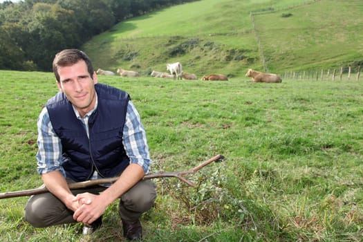 Breeder standing in pasture land