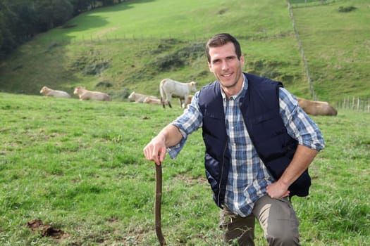 Breeder standing in pasture land