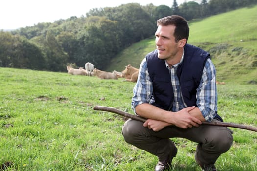 Breeder standing in pasture land