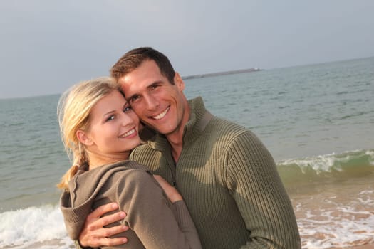 Lovers at the beach in autumn