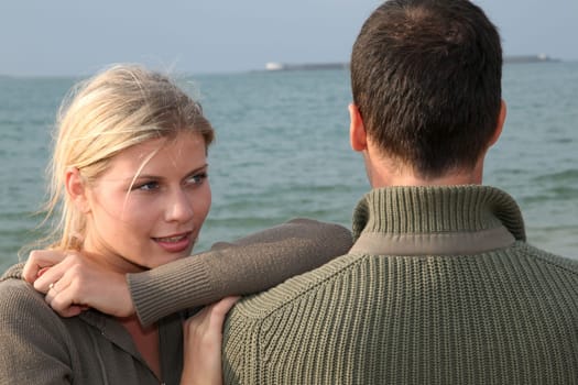 Lovers at the beach in autumn