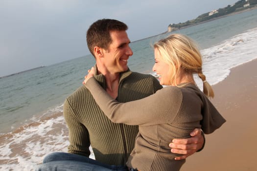 Lovers at the beach in autumn