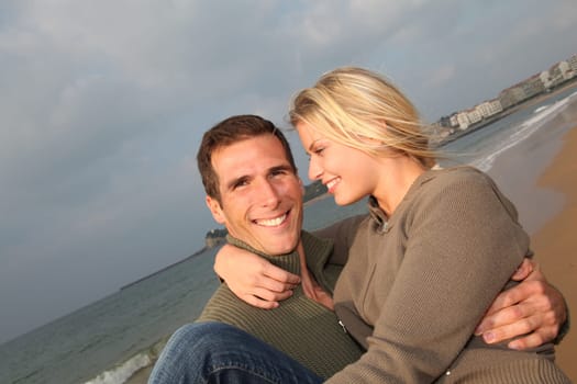 Lovers at the beach in autumn