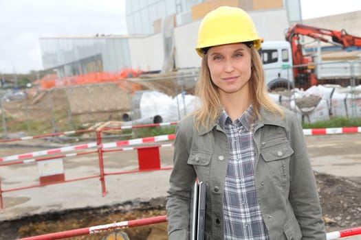Architect on construction site with security helmet