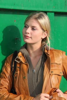 Woman standing in front of green container