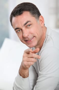Closeup of handsome man pointing at camera