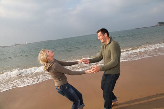 Lovers at the beach in autumn