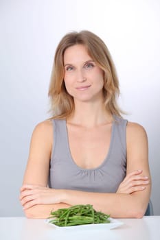 Woman in front of plate of green beans