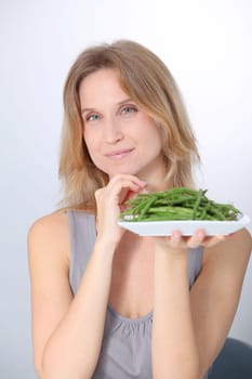 Woman in front of plate of green beans