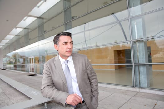Businessman standing outside modern building