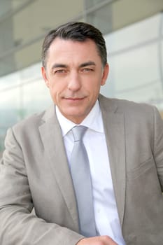 Businessman standing outside modern building