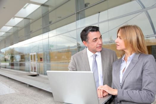 Sales people working outside modern building