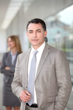 Businessman standing outside modern building