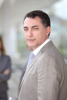 Businessman standing outside modern building