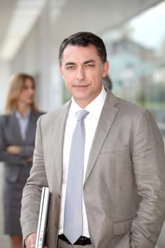 Businessman standing outside modern building