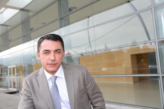 Businessman standing outside modern building