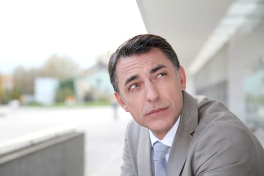 Businessman standing outside modern building