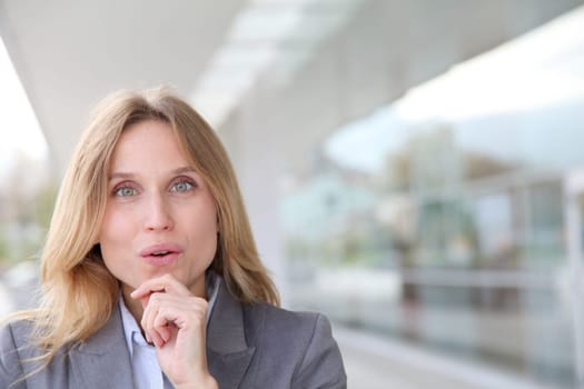 Closeup of blond businesswoman standing outside