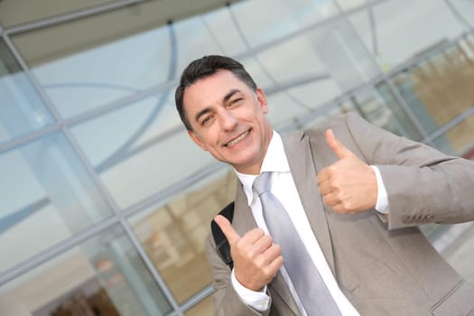 Businessman standing outside modern building