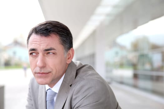 Businessman standing outside modern building