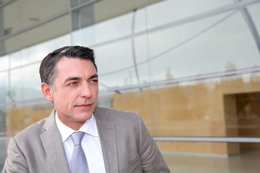 Businessman standing outside modern building
