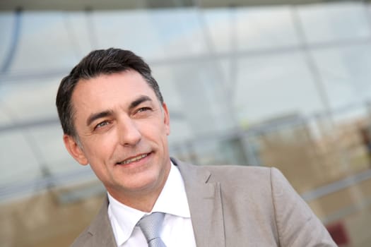 Businessman standing outside modern building