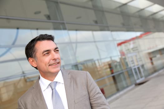 Businessman standing outside modern building