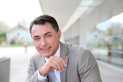 Businessman standing outside modern building