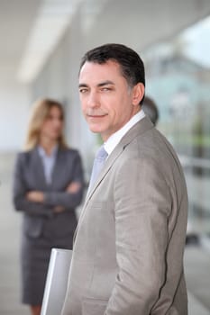 Businessman standing outside modern building