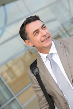Businessman standing outside modern building