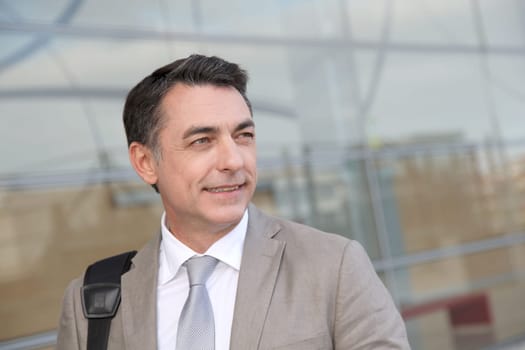 Businessman standing outside modern building